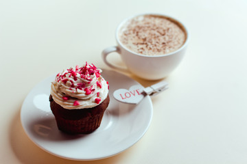 Beautiful coffee Cup with heart cupcake on white wooden background