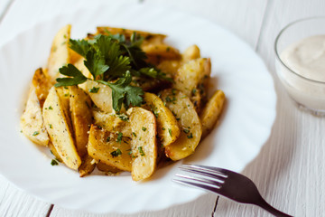 beautiful roasted potatoes with herbs and spices on a white plate
