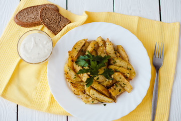 beautiful roasted potatoes with herbs and spices on a white plate