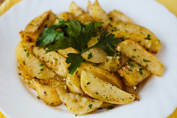 beautiful roasted potatoes with herbs and spices on a white plate
