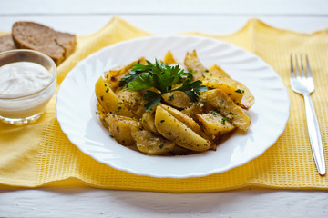 beautiful roasted potatoes with herbs and spices on a white plate