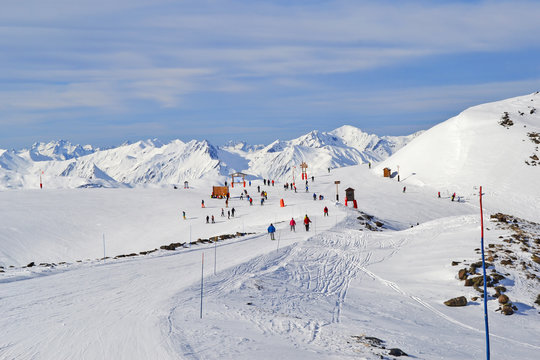 Winter landscape with mountains and mass downhill skiing