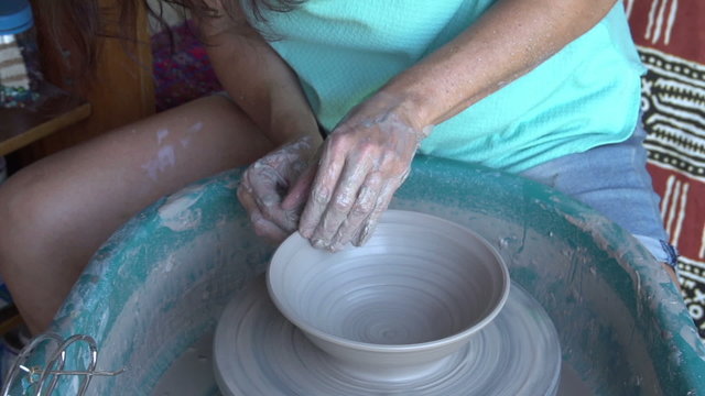 Woman throwing a pot on a potter's wheel,Cape Town, South Africa