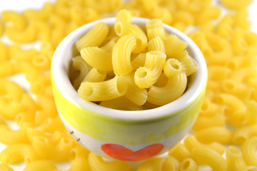 Elbow macaroni on white background