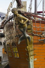 Mermaid figurehead on old sail ship. Vintage retro style.