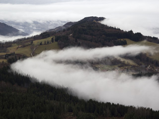 Fototapeta na wymiar Alpine village in the fog. France, rhone-Alpes