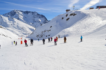Fototapeta na wymiar People skiing in a french ski resort in the Alps