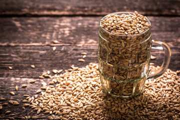 barley and hops on wooden table , beer