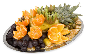 Various exotic fruits on plate. There are oranges, grapes, kiwi, piece of pineapple