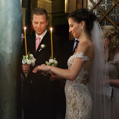 Happy emotional beautiful bride and cheerful groom with candles