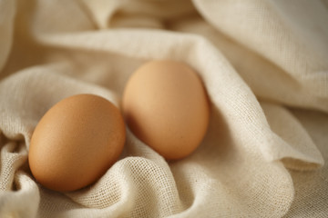 Two Brown eggs on a Cloth