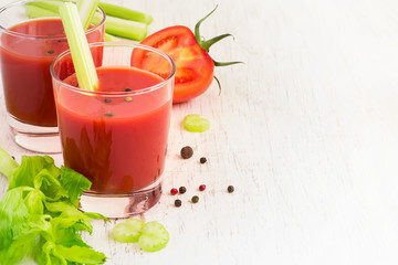 Tomato juice in a glass on a white background, space for text