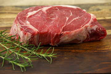 Raw Steak & Rosemary on a cutting board