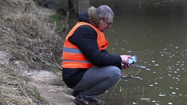 Environmental Inspector Checks The River Pollution
