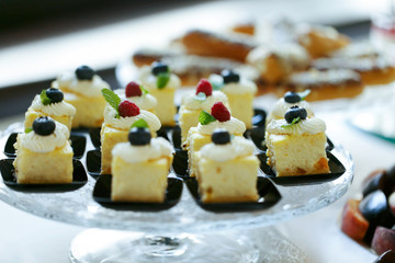 Delicious sweet cakes and pastry at wedding  dessert table recep