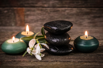 spa concept with stone and candles  on wooden table ,