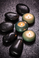 spa concept with stone and candles  on wooden table ,