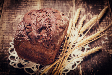 Fresh bread on wooden table ,vintage filter