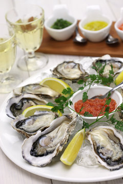fresh oysters plate isolated on white wooden background