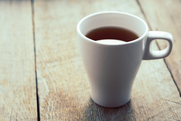 White cup on old wooden table. Horizontal format © tihayanadya