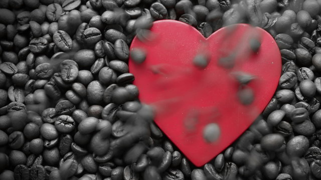 Coffee grains fill up heart. Symbol of heart on a coffee beans background. The tinted. 4K UHD video.