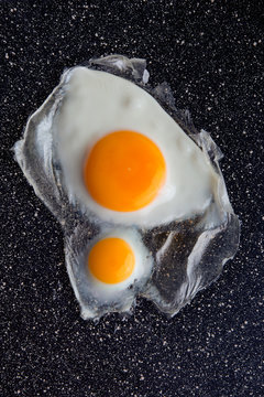 Two freid eggs on frying pen