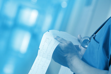 Cardiogram in doctor hands, concept of diagnosis