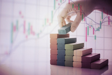 graph from block wood with hand and money concept