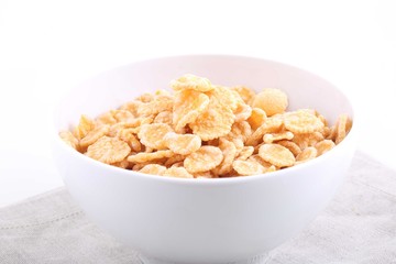 Corn and rice flakes in a cup on a white background
