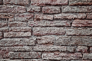 Old stone wall. To use for the background.  Applied light and color effects to create the dramatic atmosphere of the picture. Changes of contrast. The vignetting. Artistic technique.
