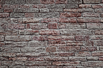 Old stone wall. To use for the background.  Applied light and color effects to create the dramatic atmosphere of the picture. Changes of contrast. The vignetting. Artistic technique.
