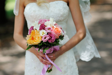 Bride Holding Wedding Bouquet with Orange white and Pink Flowers