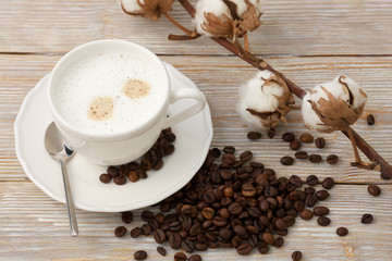 Morning coffee with cream and cotton flower