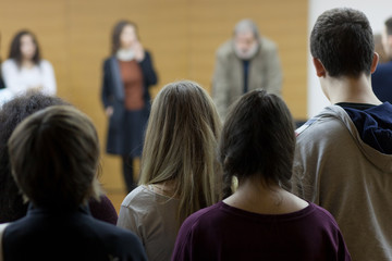students standing at lecture
