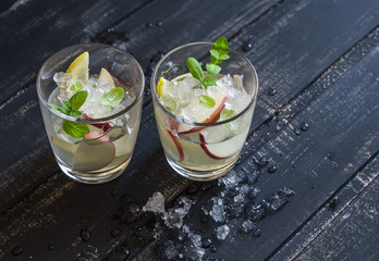 Apple, lemon and mint homemade lemonade on a dark wooden background