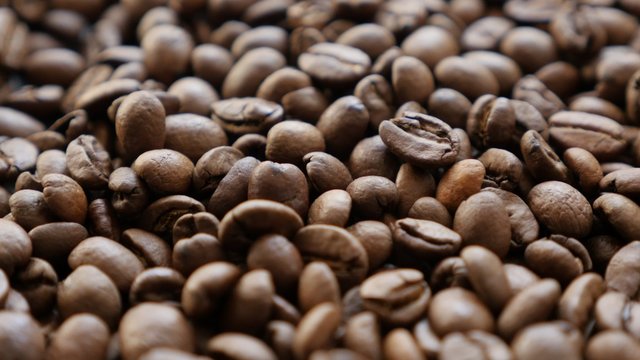 High flavour Arabica type coffee beans roasted and arranged slow tilt 4K 2160p 30fps UHD footage - High quality espresso coffee Arabica coffee beans background 4K 3840X2160 UltraHD tilting video 