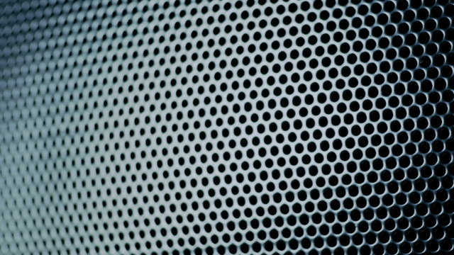 Dark metal background with perforated holes. 4K 3840x2160 UHD video.
