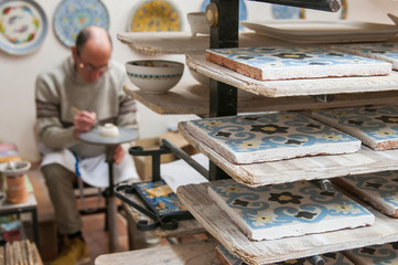 Close up view of painted ceramic tiles in the shelf of a pottery workshop in Caltagirone, Sicily