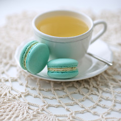 Blue macarons with a cup of green tea