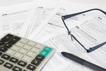 Naklejka na ściany i meble US tax forms with calculator, glasses and pen.