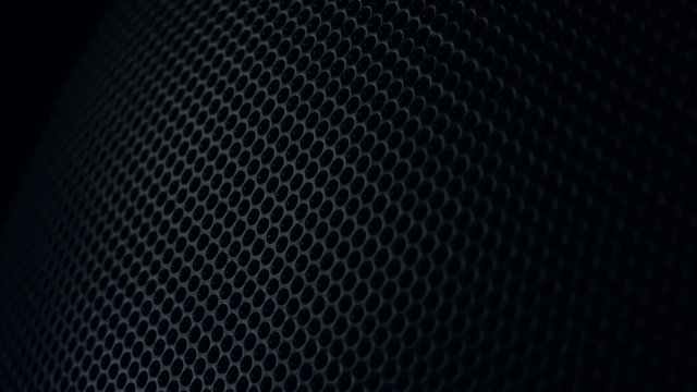 Metallic grid motion background. Dark metal background with perforated holes. 