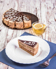 cup of coffee and delicious cake on wooden table