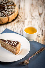 cup of coffee and delicious cake on wooden table