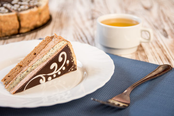 Slice of Layered Cake with a cup of tea