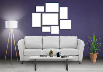 Isolated group of wall art frames. Sofa, lamp, plant and table in room interior.