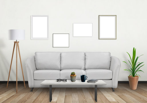 Isolated group of wall art frames. Sofa, lamp, plant and table in room interior.