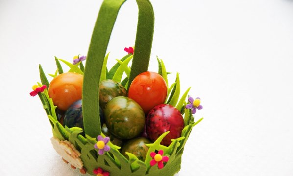Easter egg painted in a decorative textile basket