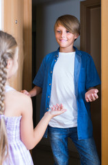 child receiving expected friend at home interior