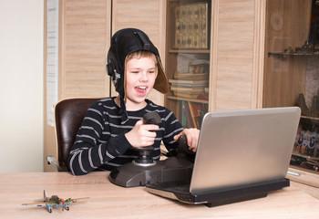 Gamer. Happy boy playing online pc game. Kid play video games.