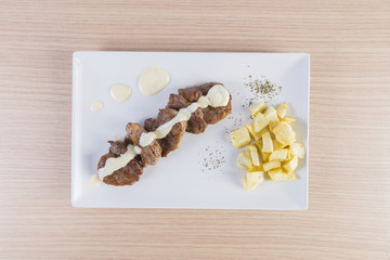 Solomillo de ternera con salsa de queso y patatas fritas.